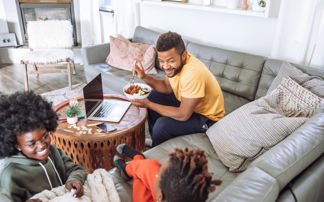 man in yellow crew neck t-shirt sitting on brown wooden chair